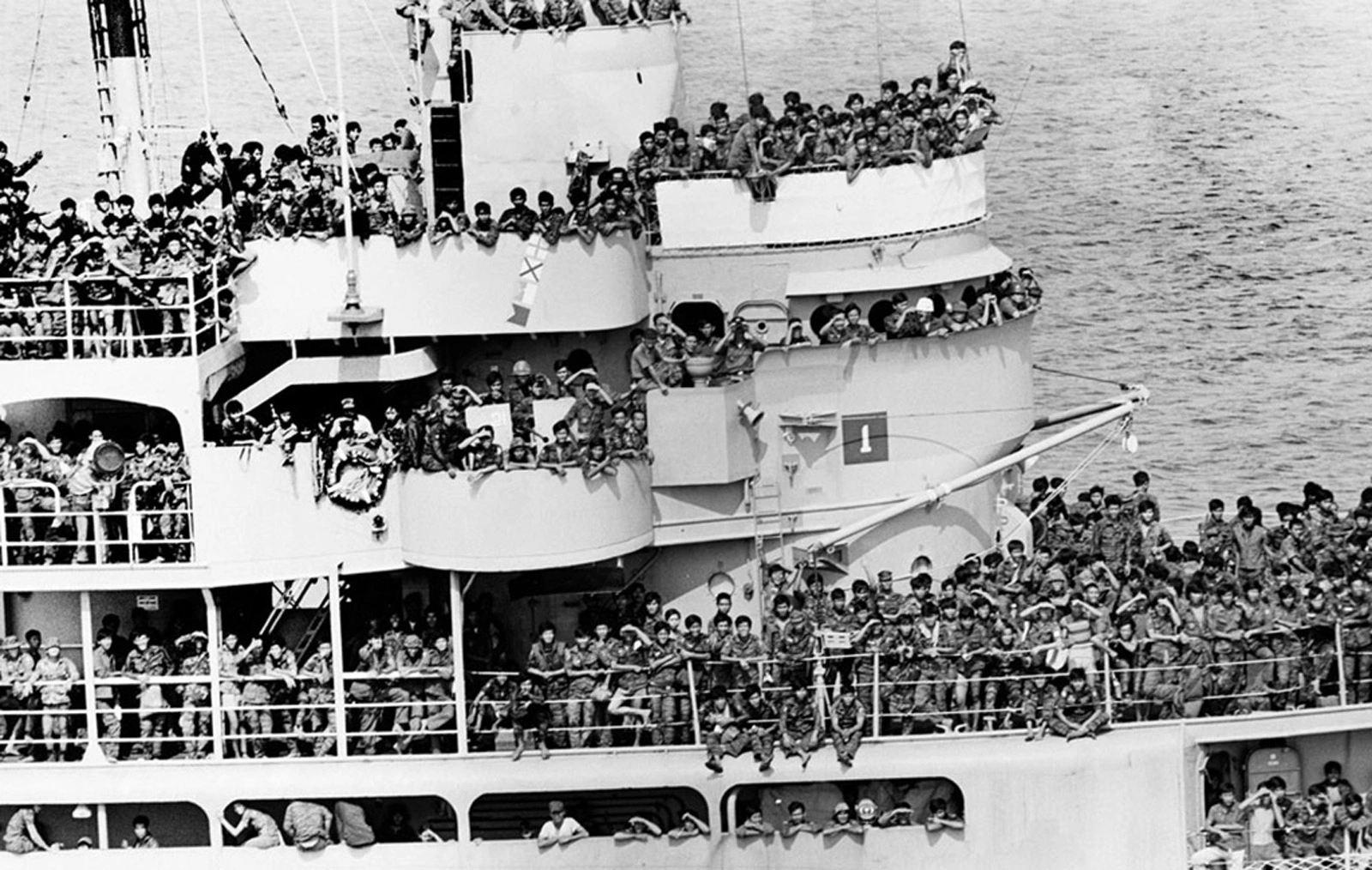 Troop Transport Ship, Military Personnel, Naval Vessel, Crowded Decks, Soldier Transport, Black and White Photo, Military Mobilization, Combat Helmets, Deployment, War Transit, Soldier Readiness, Military Journey, Sea Deployment, Armed Forces Movement, Historical Military Transport, Warzone Deployment, Military Scale, Soldier Anticipation, Service Member Experience