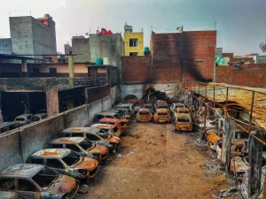 burnt vehicles, riot aftermath, damaged cars, urban destruction, charred remains, Delhi Riots, desolation, fire damage, building damage, post-conflict scene, delhi riots, delhi riots 2020, 2020 delhi riots